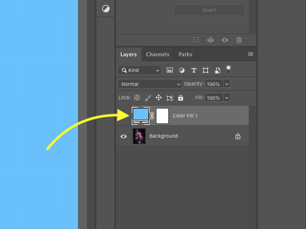 Close up of Photoshop's layers panel with one locked background image and one solid adjustment layer with layer mask. Yellow arrow pointing to solid blue layer.